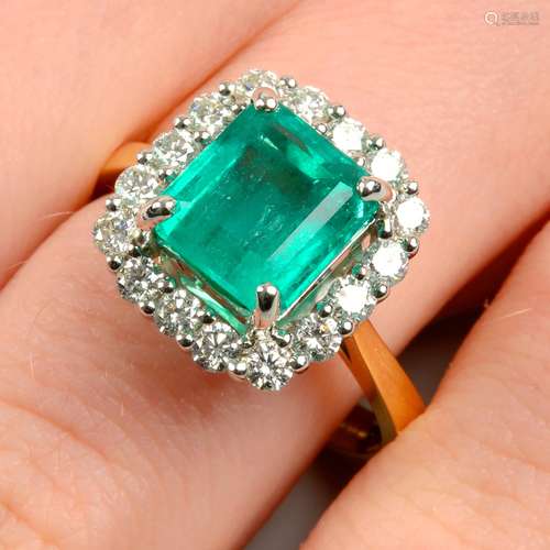 An 18ct gold emerald and diamond cluster ring.