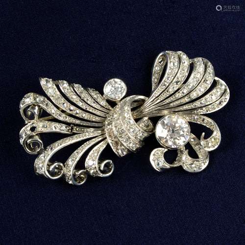 A mid 20th century platinum old-cut diamond scroll brooch.