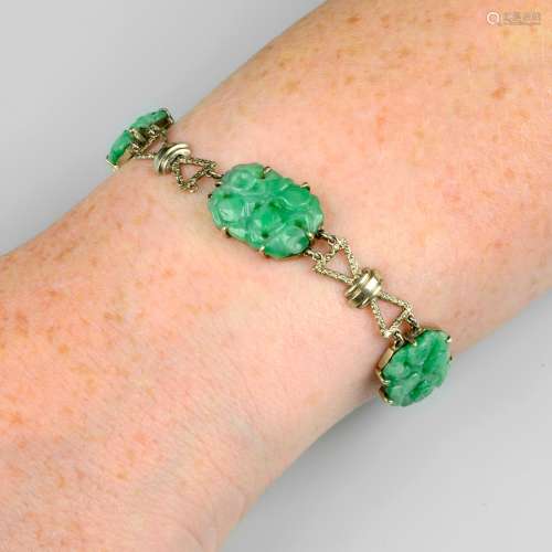 An Art Deco gold carved jade bracelet.