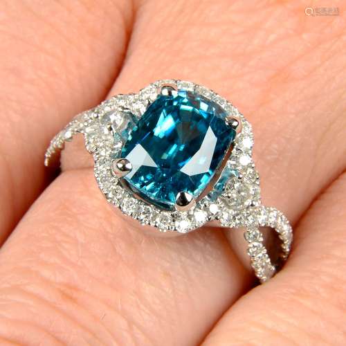 A blue zircon and diamond dress ring.Estimated dimensions of...