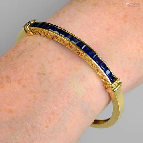 A sapphire and brilliant-cut diamond hinged bangle.Estimated...