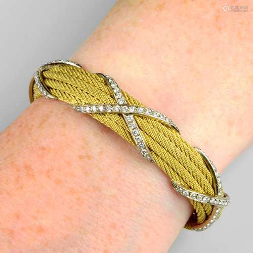 A rope-twist bangle, with pavé-set diamond cross highlights.