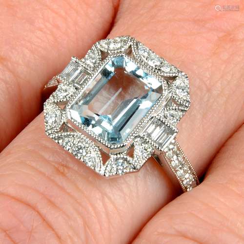 An 18ct gold aquamarine and diamond dress ring.Aquamarine we...