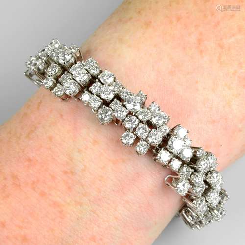 A brilliant-cut diamond abstract cluster line bracelet.