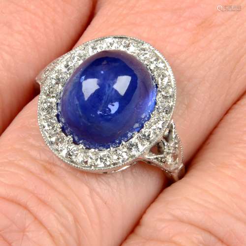 A sapphire cabochon and diamond dress ring.