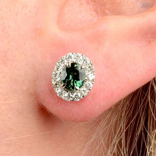 A pair of green sapphire and brilliant-cut diamond earrings....