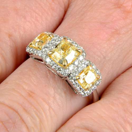 A 'yellow' diamond and diamond three-stone cluster ring.Esti...