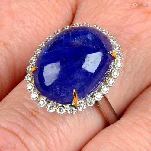 A tanzanite cabochon and brilliant-cut diamond cluster ring....