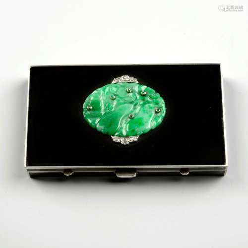 An Art Deco silver, carved jade, emerald, diamond and black ...