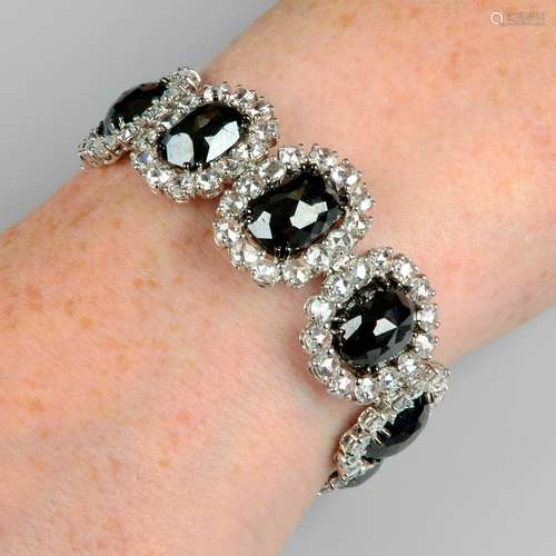 A slightly graduated 'black' diamond and rose-cut diamond cl...