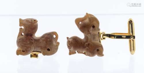 A pair of green/brown jade cuff links, carved as mythical be...