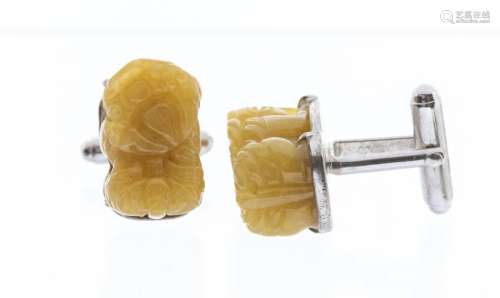 A pair of yellow jadeite stones carved as Buddhistic lions, ...