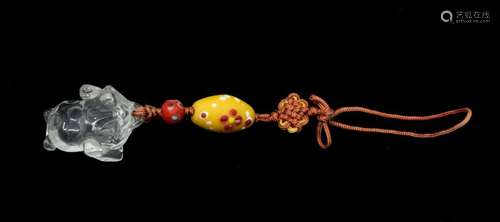 A rock crystal toad and two beads, each decorated with 'eyes...