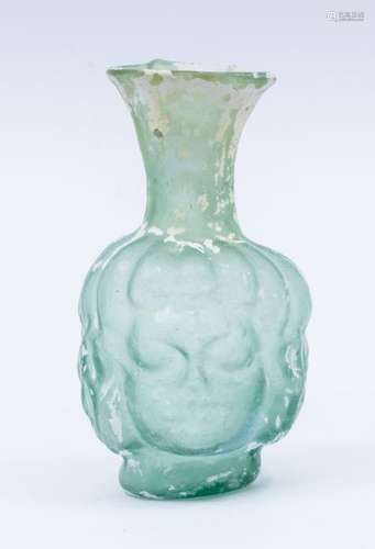 A rare glass tear vase with moulded human portrait decoratio...