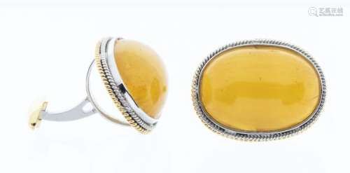 A pair of Buddhist amber cabouchon cuff links, mounted in 18...