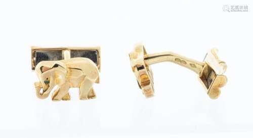 Cartier, a pair of 18k gold elephant cuff links, emeralds fo...