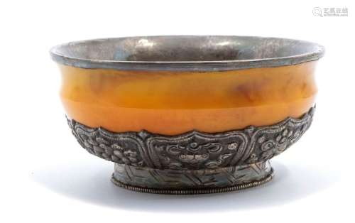 A Bhutan silver-mounted amber bowl, the base of the bowl wit...