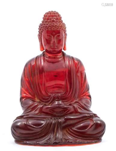 A Chinese moulded amberine figure of Buddha, the figure seat...