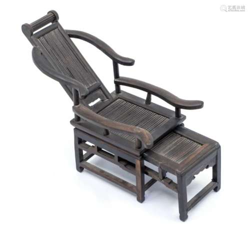 A Chinese zitan wood miniature reclining chair and foot stoo...