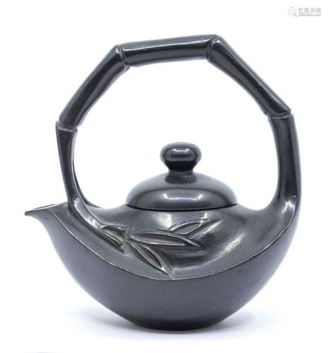 A black shousan stone teapot and cover, carved with a simula...