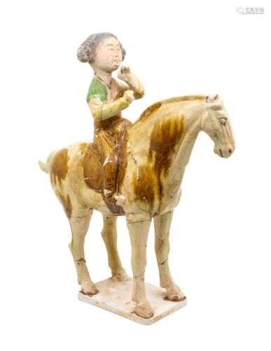 A Chinese sancai-glazed pottery horse and female rider, the ...