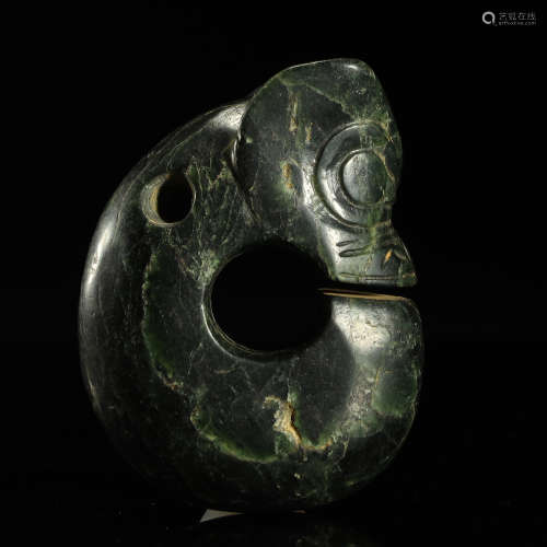 A CELADON AND RUSSET JADE 'PIG DRAGON' CARVING NEOLITHIC PER...