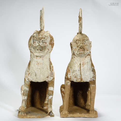 TANG DYNASTY,A PAIR OF PAINTED POTTERY MYTHICAL BEASTS