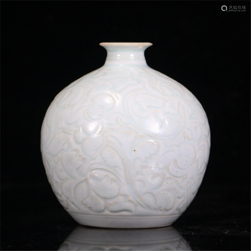 A CHINESE DING-STYLE GLAZED PORCELAIN CARVED FLOW…