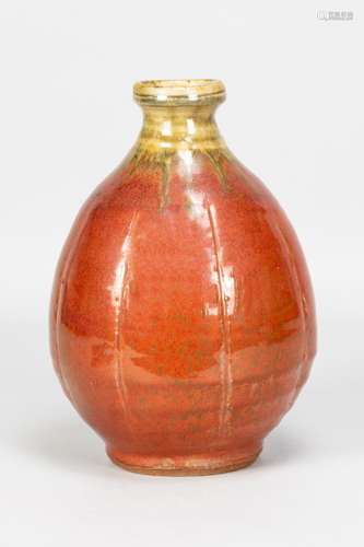 MIKE DODD (born 1943); a stoneware bottle covered in red gla...