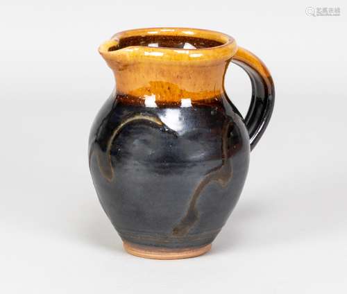 CLIVE BOWEN (born 1943); a small slipware jug covered in dar...