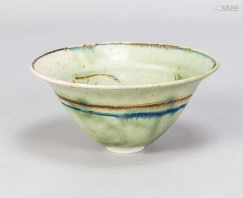 KATSUJI TANIGUCHI; a porcelain bowl covered in pale green gl...