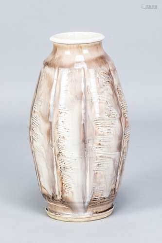 Odney Pottery; a faceted earthenware vase covered in white g...