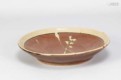 SHOJI HAMADA (1894-1978); a large stoneware plate with wax r...