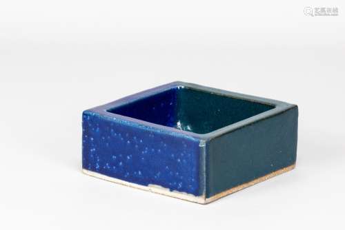 IAN AULD (1926-2000); a square dish covered in dark turquois...