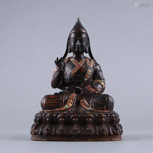 A GEM-SET GILT-BRONZE FIGURE OF TSONGKAPA