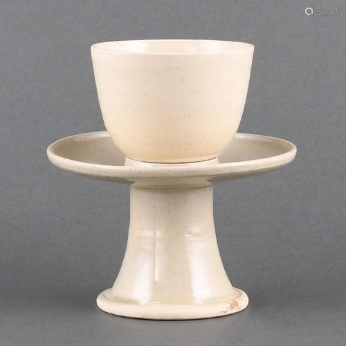 A RARE WHITE WARE CUP AND CUPSTAND
