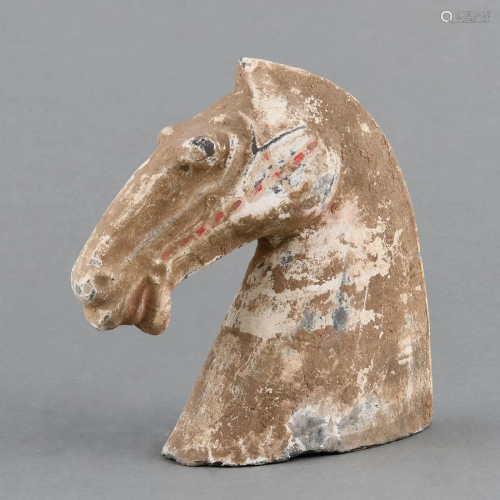 A PAINTED EARTHENWARE HORSE HEAD