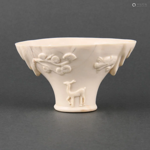 A DEHUA RHINOCEROS HORN-FORM LIBATION CUP