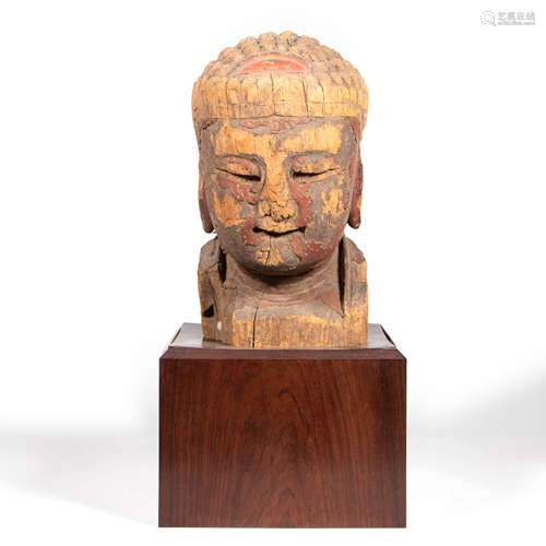 A Carved Wood Buddha Head