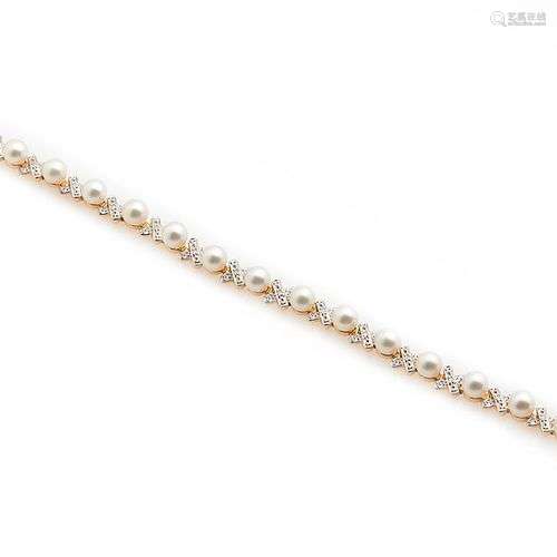 Bracelet ligne en or jaune 18k (750/°°), composé de fleurett...