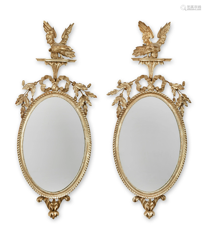 A PAIR OF EARLY 19TH CENTURY CARVED SILVERED MIRRORS