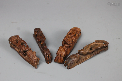 A Group of Four Carved Birch Belt Buckles