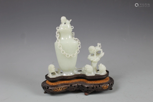 A Carved White Jade Figural Group and Urn With Stand