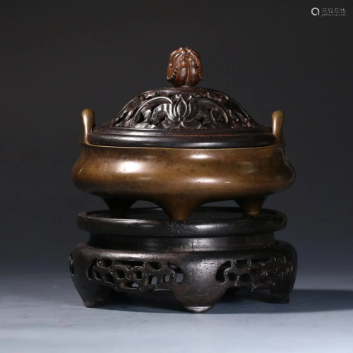A CHINESE BRONZE DOUBLE HANDLED TRIPOD INCENSE BURNER