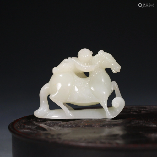 A CHINESE JADE CARVING OF CHILD RIDING A HORSE