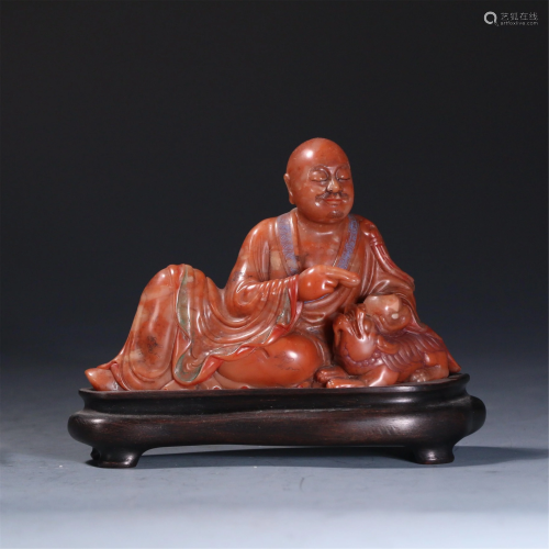A CHINESE SOAPSTONE CARVED STATUETTE OF ARHAT