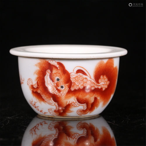 A CHINESE WHITE GROUND IRON-RED LIONS PORCELAIN CUP