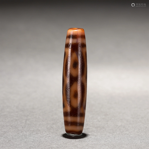 A CHINESE SEVEN-EYED DZI BEAD