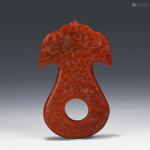 A CHINESE CARVED RED HARD-STONE DECORATION