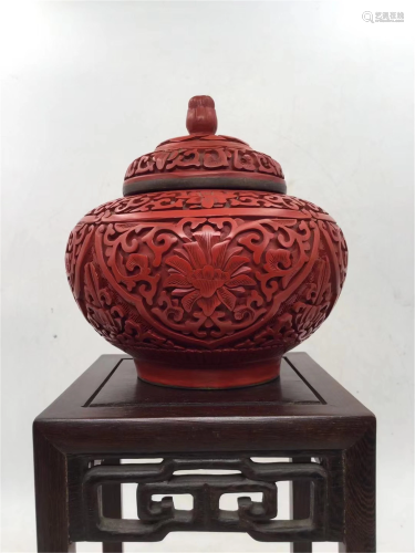 A CARVED RED LACQUER FLORAL TEA-LEAF JAR AND COVER
